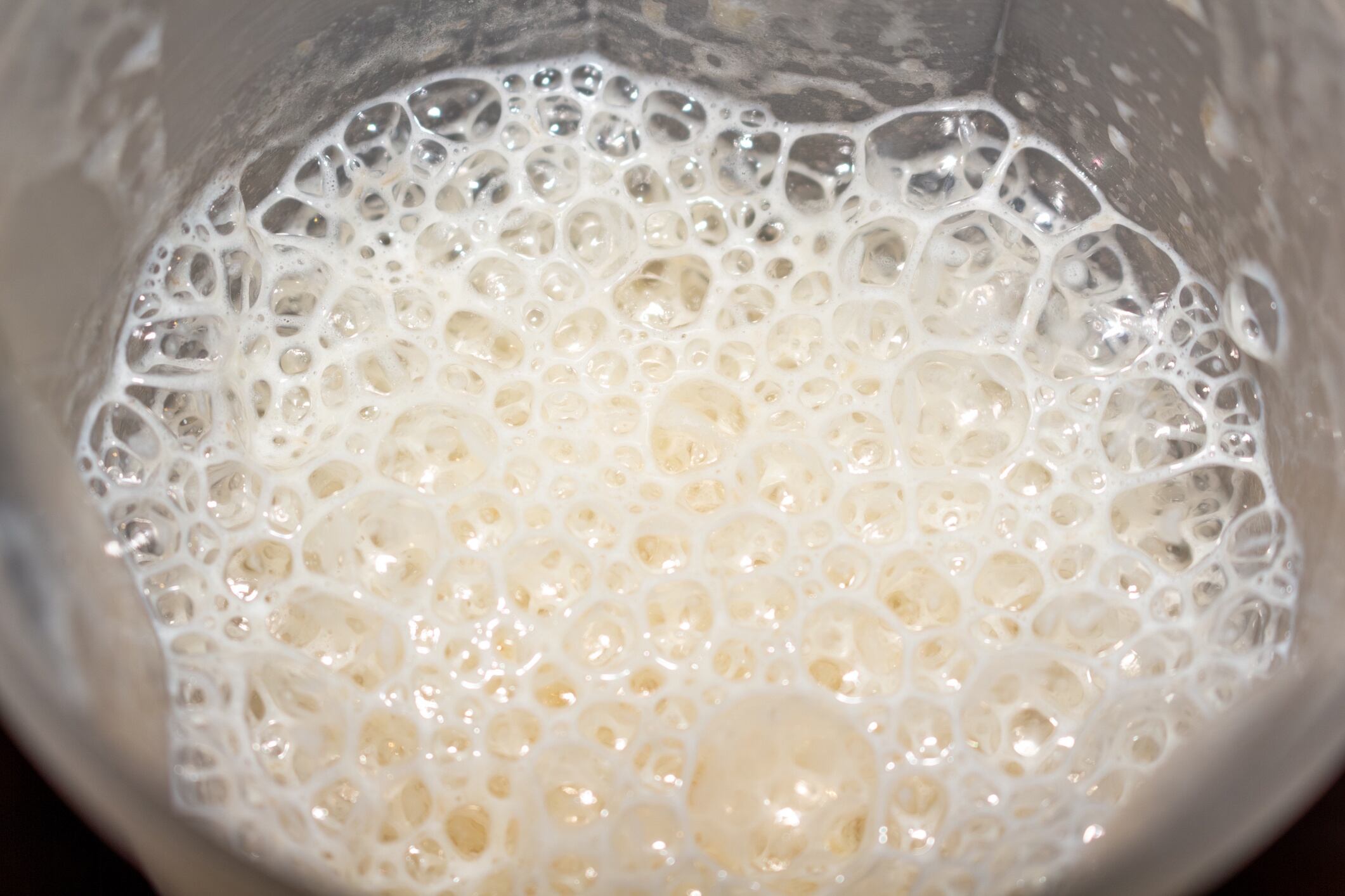 A vibrant creamy mixture with abundant bubbles in a stainless steel container for cooking or baking process Ilya Getty Images