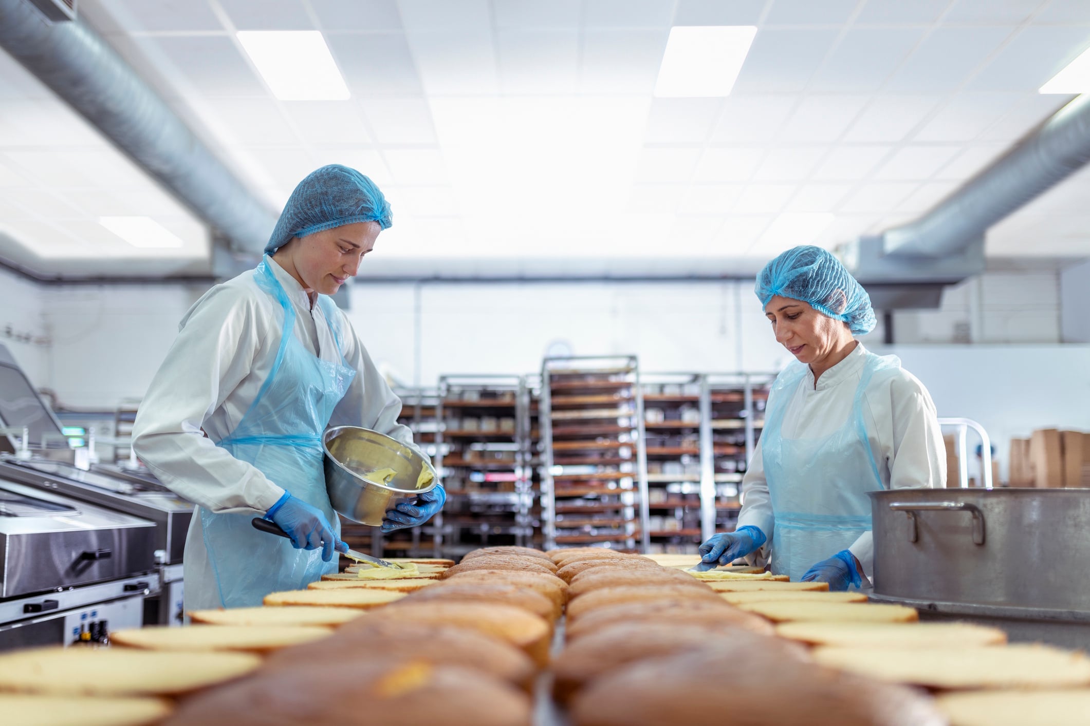 Female workers filling cakes in cake factory Monty Rakusen GettyImages