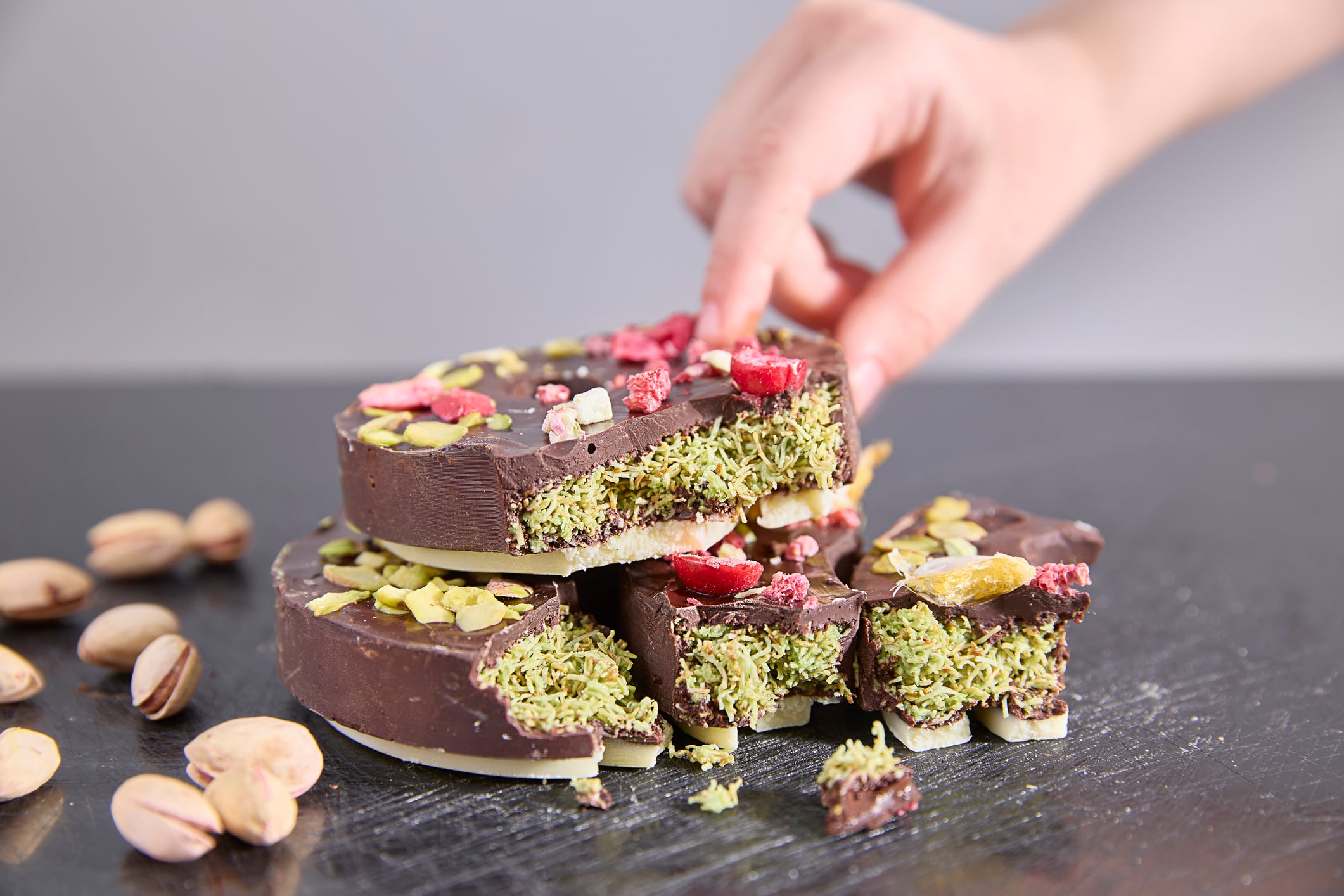 Dubai chocolate. Rich moments, decadent delights, pistachio and cherry topped chocolate slices promise sweet indulgence, perfect for food bloggers, bakers, or tempting treats imagery.