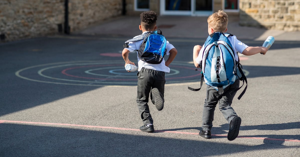 Photo: bakeryandsnacks.com Kids with school backpacks running into school