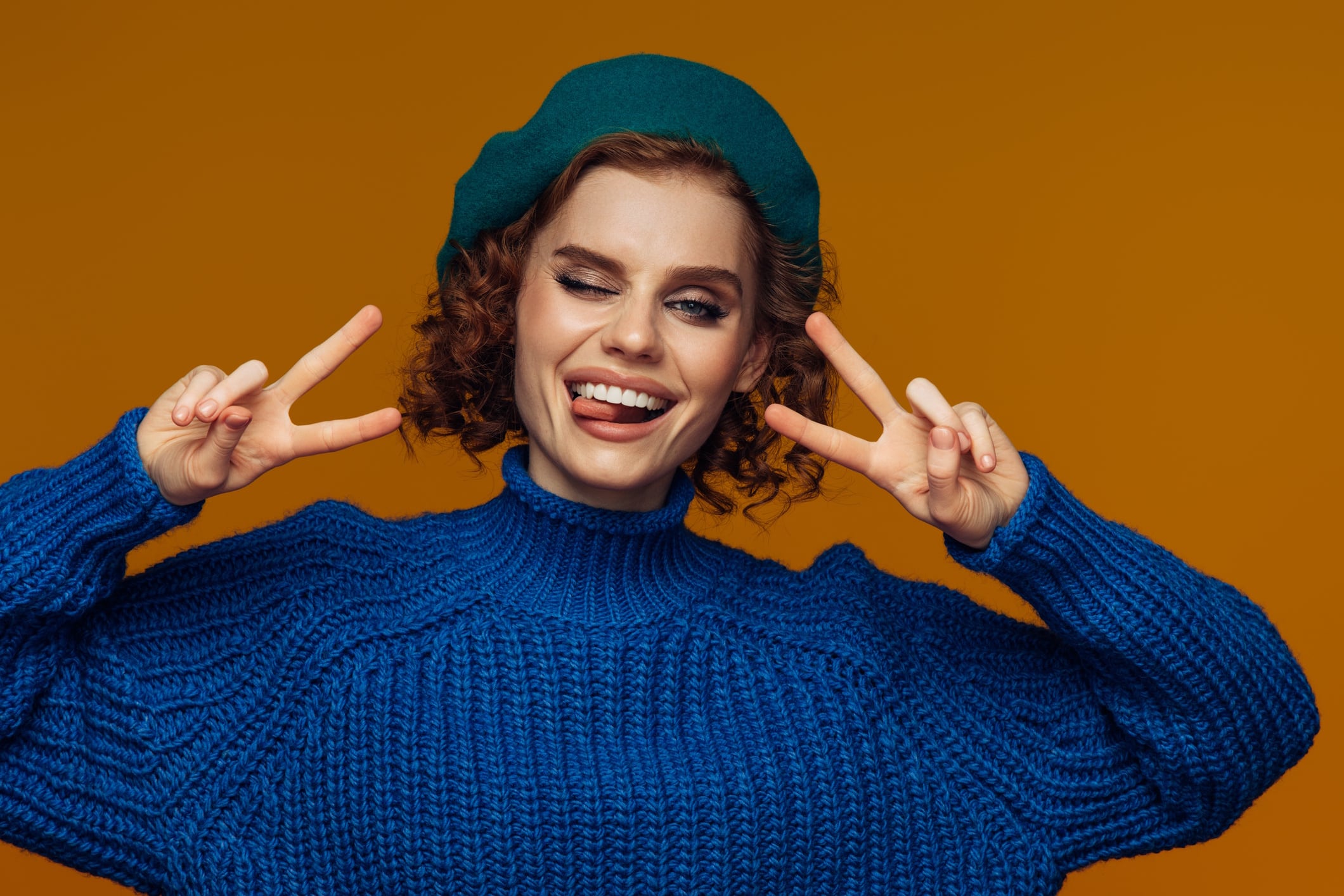 Woman in Blue Sweater Making a Peace Sign