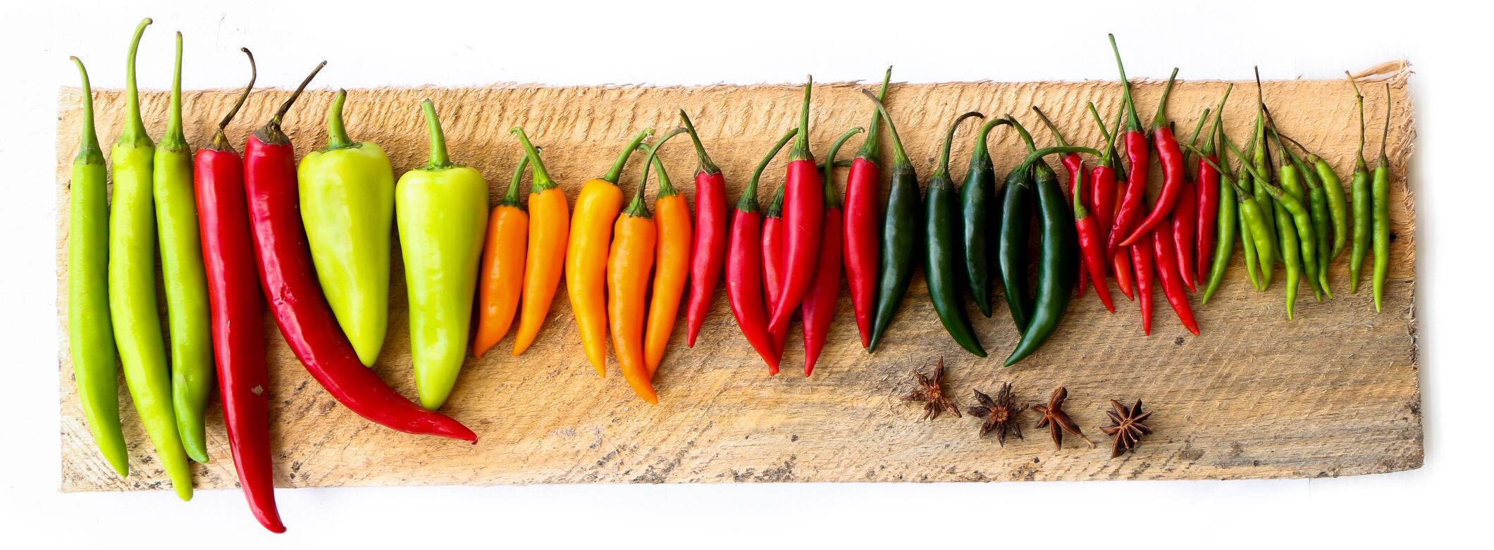 Group of colorful chili put on wooden thawornnurak GettyImages