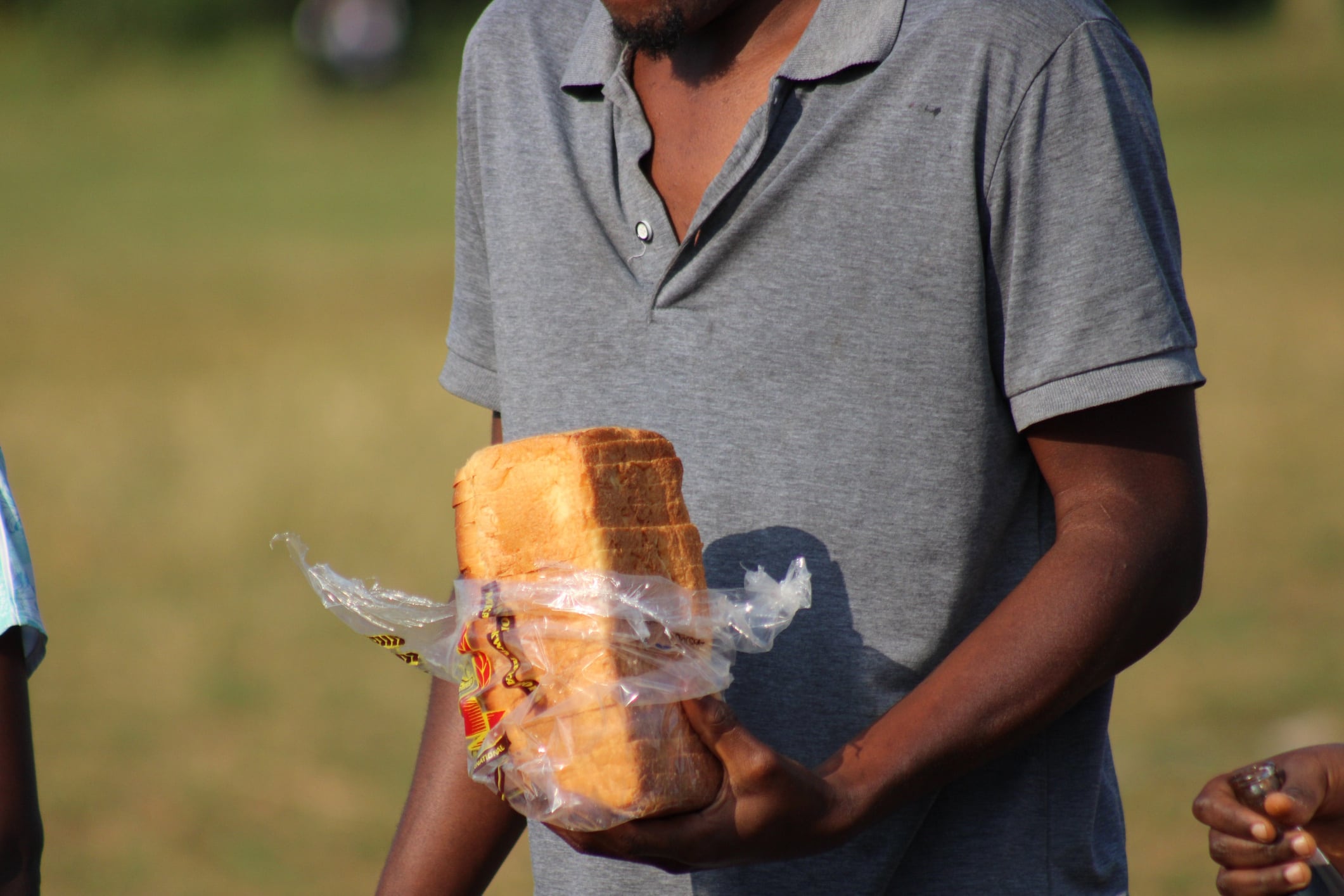 African man holding a loaf of bread OLAIS ROGERS