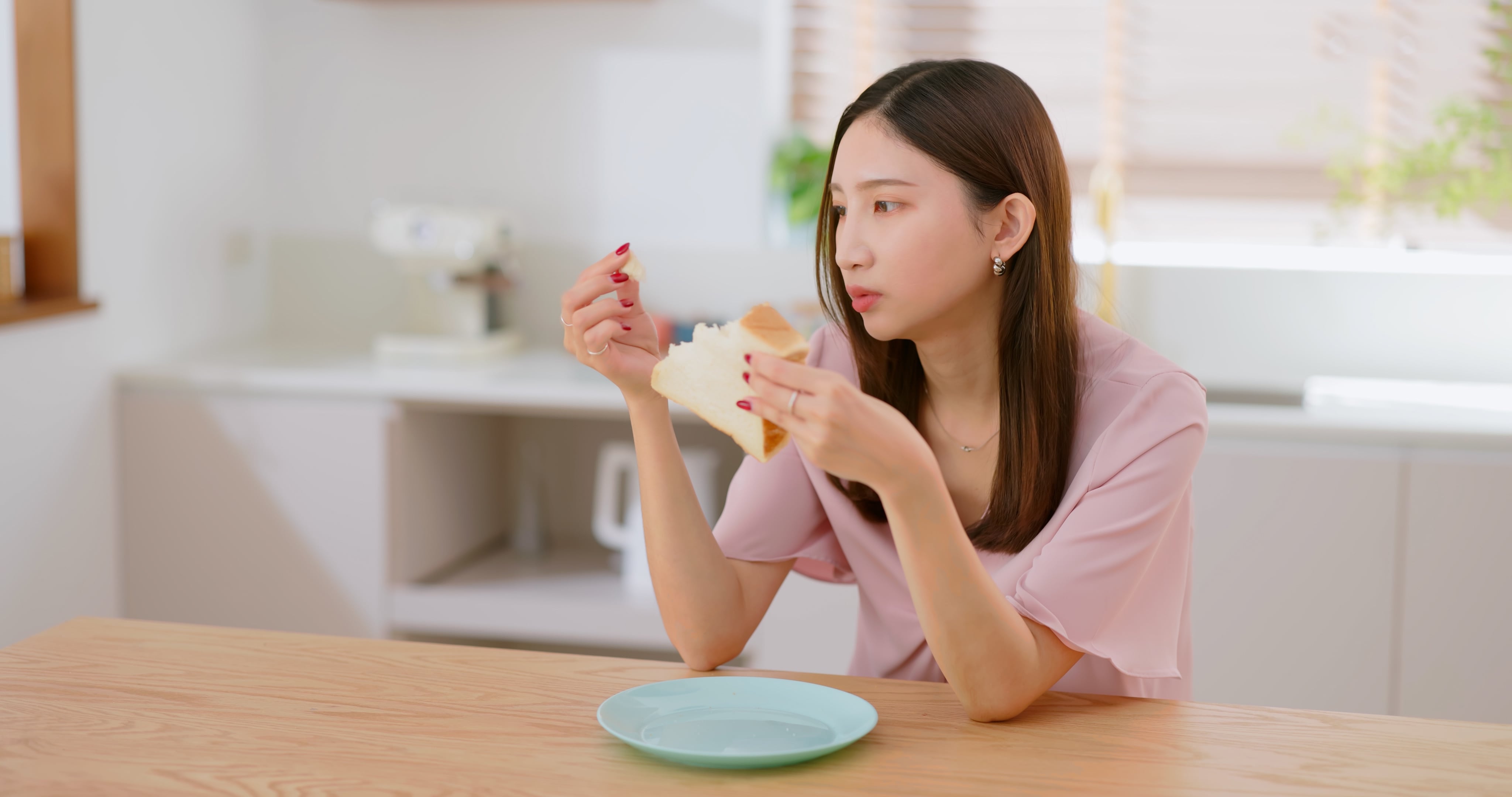 Woman eat white toast home