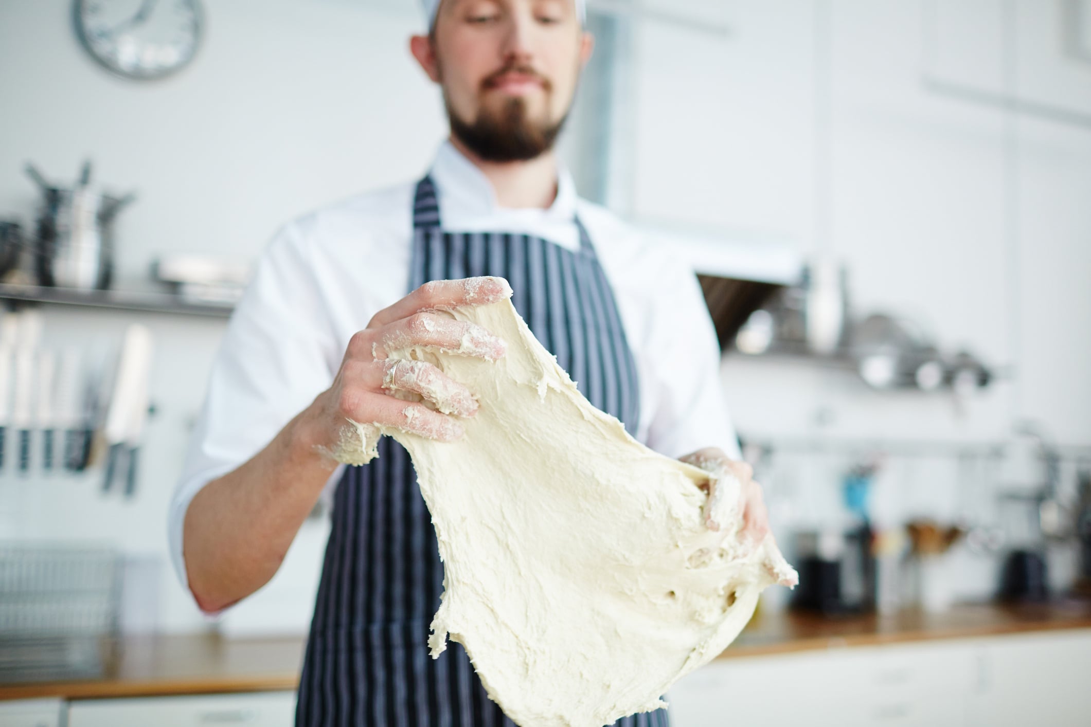 Bakery chef kneading dough and making flatbread Pressmaster GettyImages