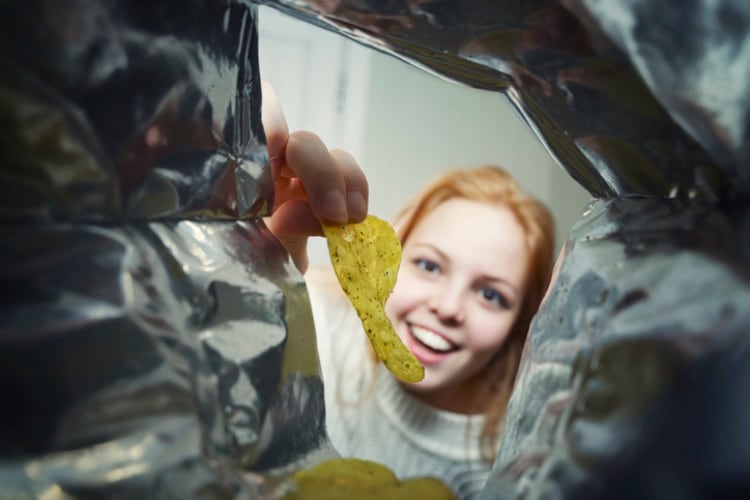 Girl-eating-chips-Getty-Elena-Gurova.jpg