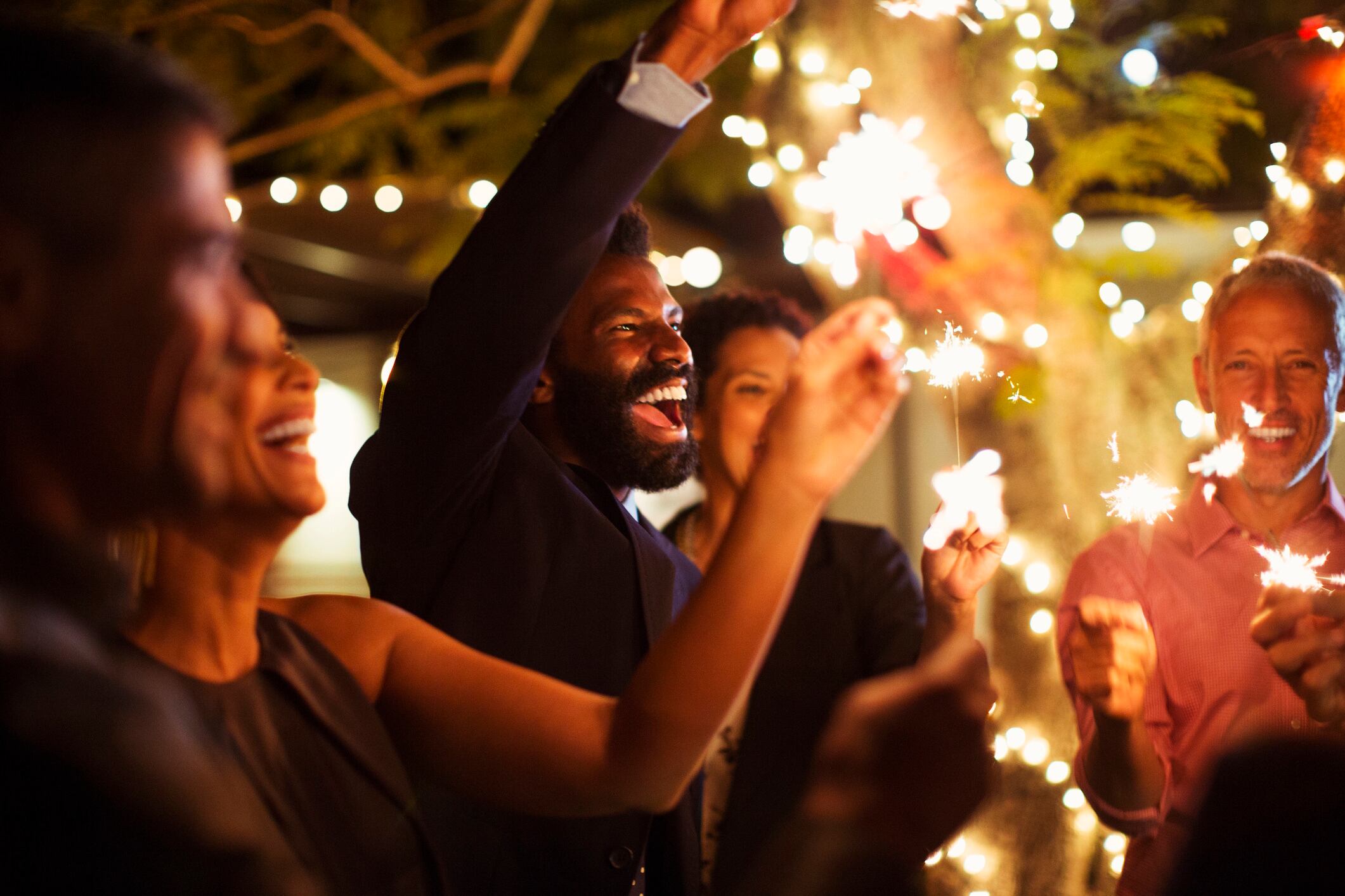 Friends playing with fireworks at a party Caiaimage Paul Bradbury GettyImages