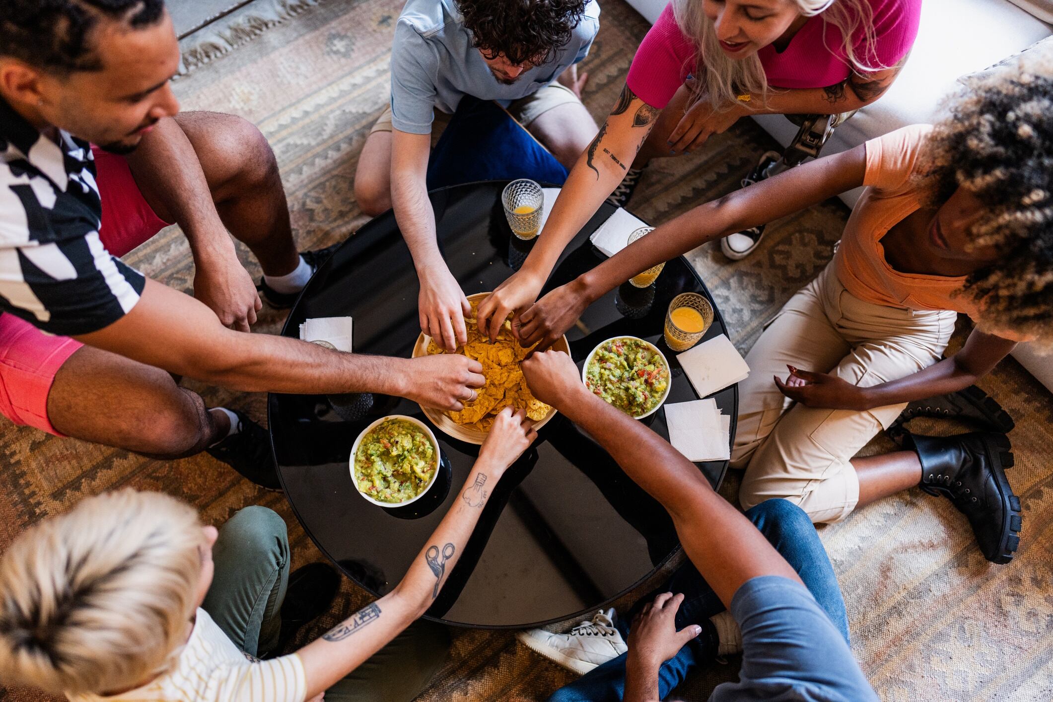 Friends eating tortilla chips