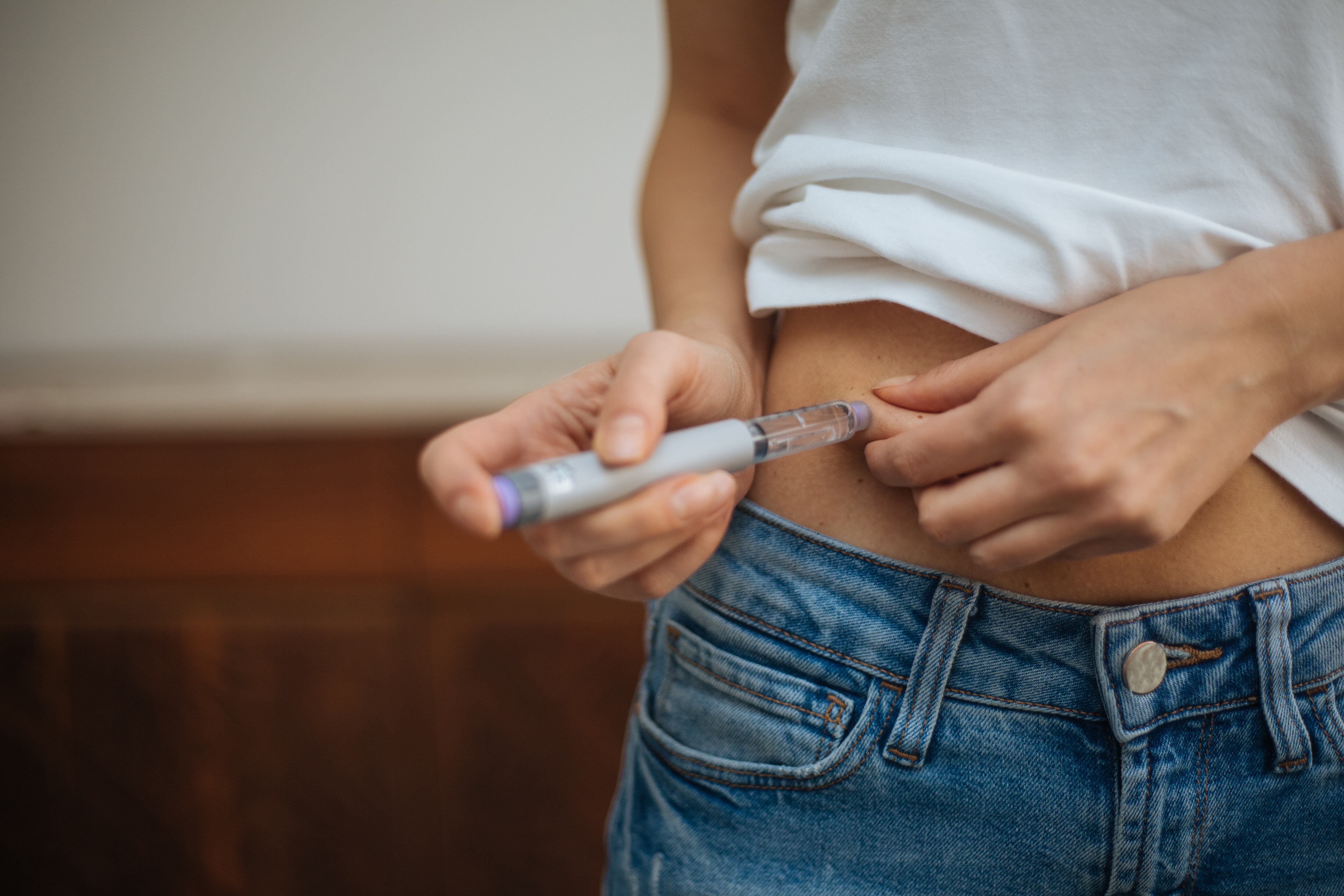 Woman injecting GLP-1 drug