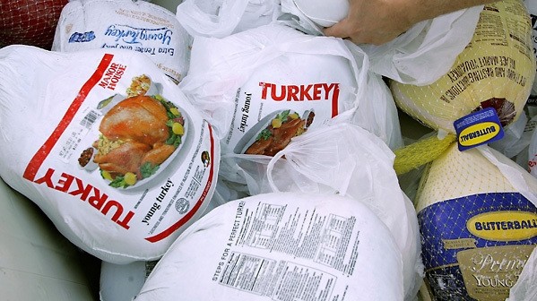 Conventional turkey packaging (plastic-wrapped bird in a mesh bag) can be difficult to carry.