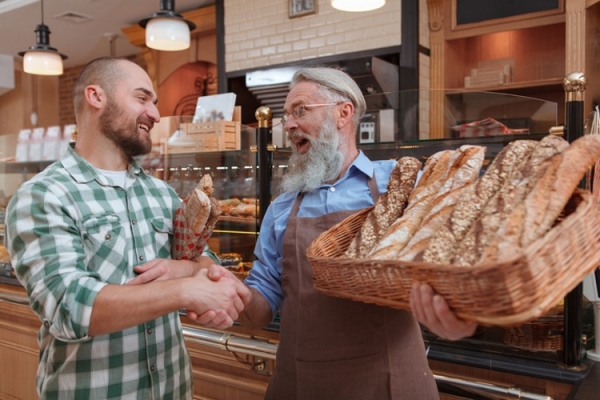 Baker shaking hands with consumer Ilhor Bulyhin