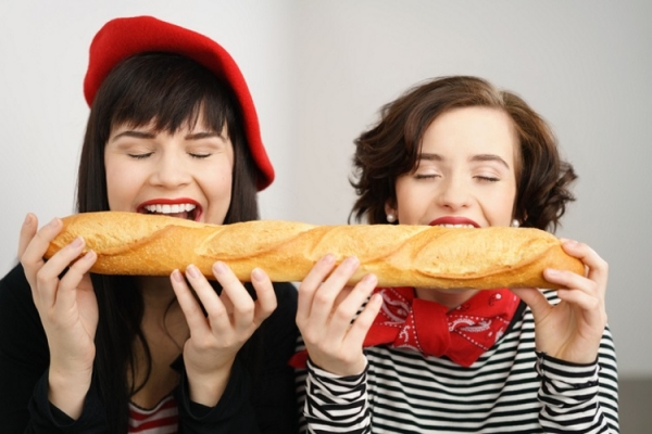French ladies eating a baguette stockfour