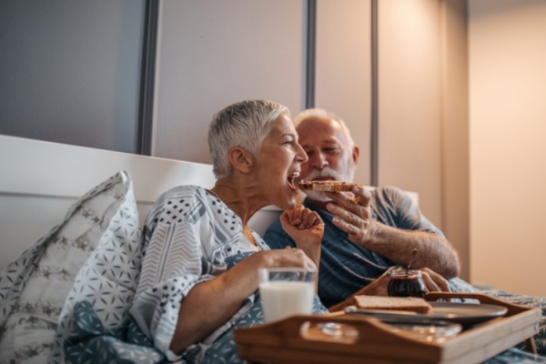 Getty Images - old couple eating bread in bed bernardbodo