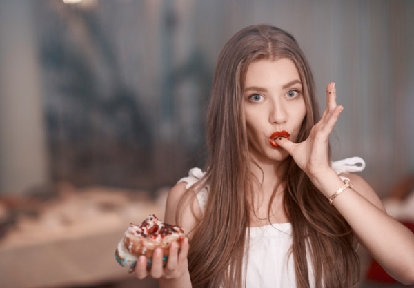 Woman eating a doughnut stock_colors