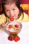 Chinese girl eating cereal. ktaylorg