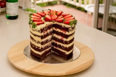 Tall bakes, like this chocolate double barrel tall layered cake decorated with strawberries, will be all the rage this year. Pic: Daria Nipot